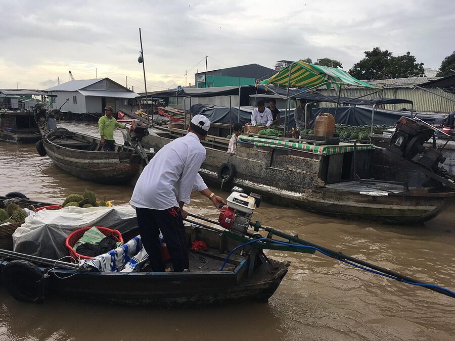 Cai Rang floating market on the Hau River, wider angle showing trading boats