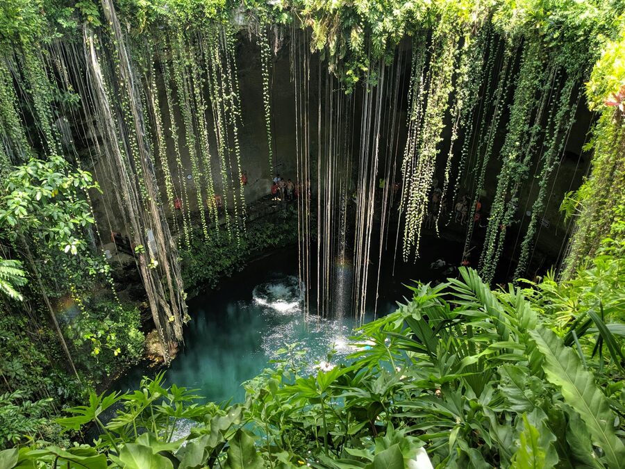 Cenote Ik Kil surrounded by lush greenery in Yucatan, Mexico