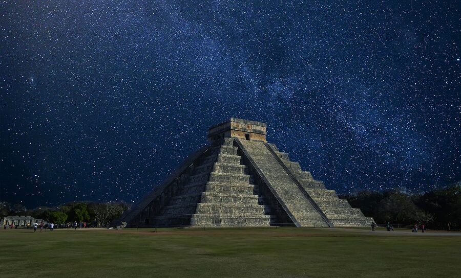 The Milky Way arching over the El Castillo pyramid at Chichen Itza on a starlit night