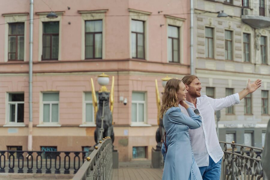 A happy couple exploring the city by a historic bridge