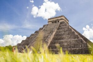 The Temple of Kukulcan pyramid at Chichen Itza under a clear sky