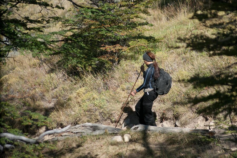 A woman trekking through El Chalten trails in Patagonia, Argentina, surrounded by nature