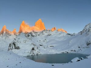 Snow-covered Fitz Roy illuminated by sunrise alpenglow in Santa Cruz, Argentina