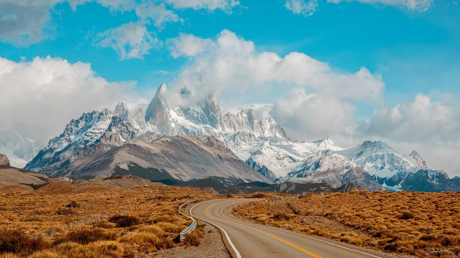 View of Mount Fitz Roy in Patagonia, Argentina, with a winding road leading into the foreground