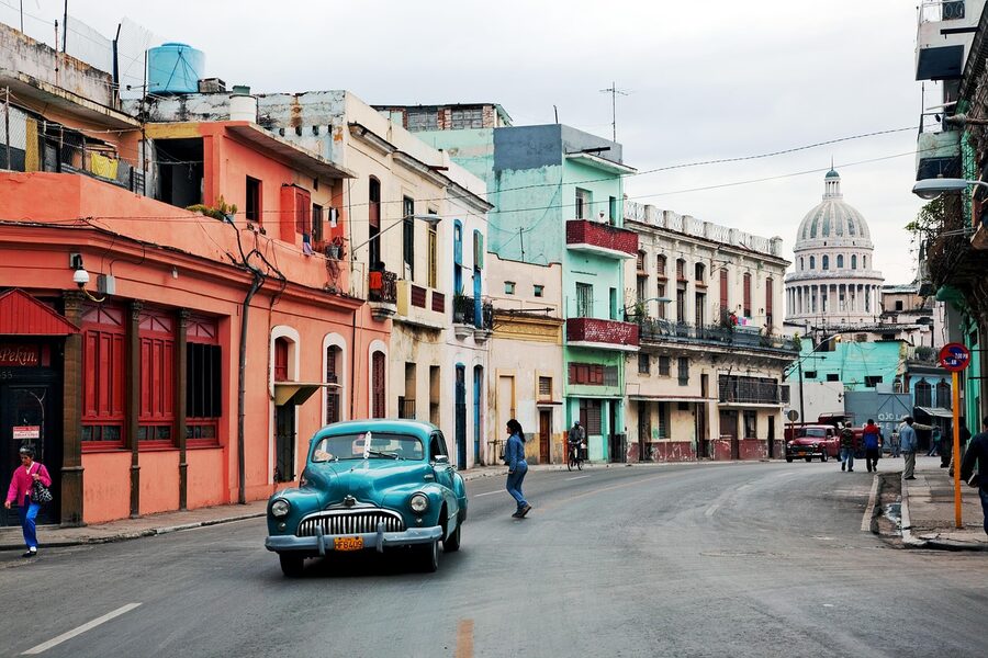 Classic American cars parked on a colonial street in Havana, Cuba