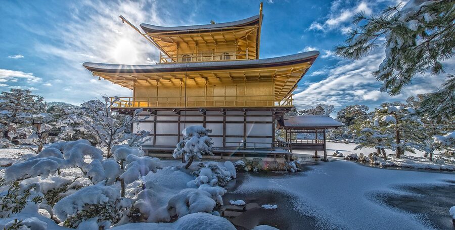 The Golden Pavilion temple Kinkaku-ji in Kyoto with snow on the roof