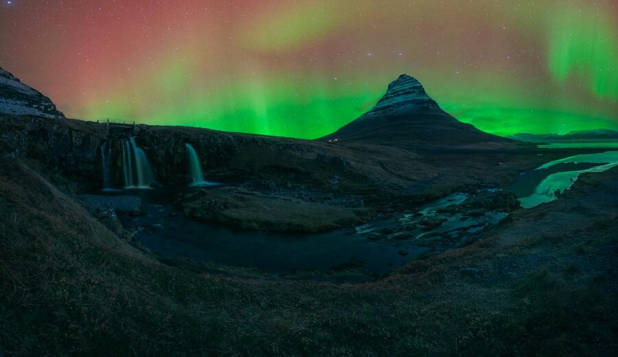 Northern Lights illuminating the sky above Kirkjufell mountain, Iceland