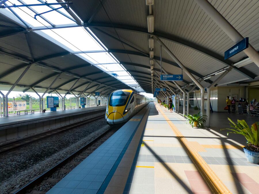 A sleek KTM intercity train at a contemporary station in Gopeng, Malaysia