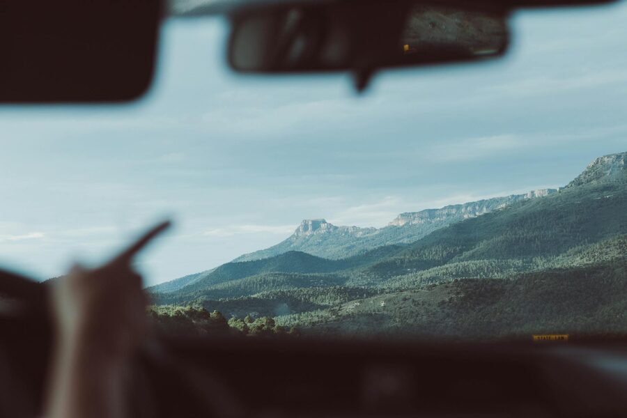 A view of mountain ranges in Colorado through a car windshield