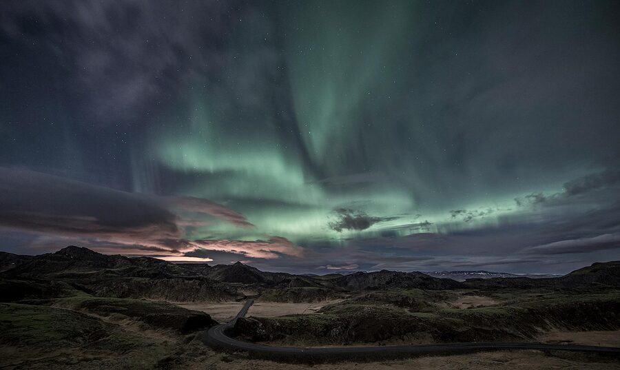 The Northern Lights illuminate the Icelandic landscape at night