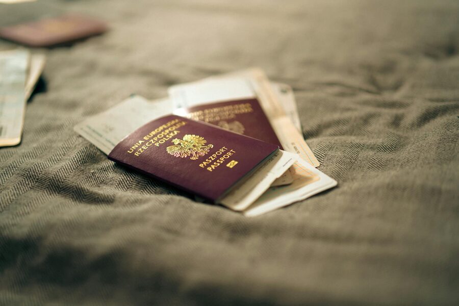A close-up of a passport and travel documents placed on a fabric surface