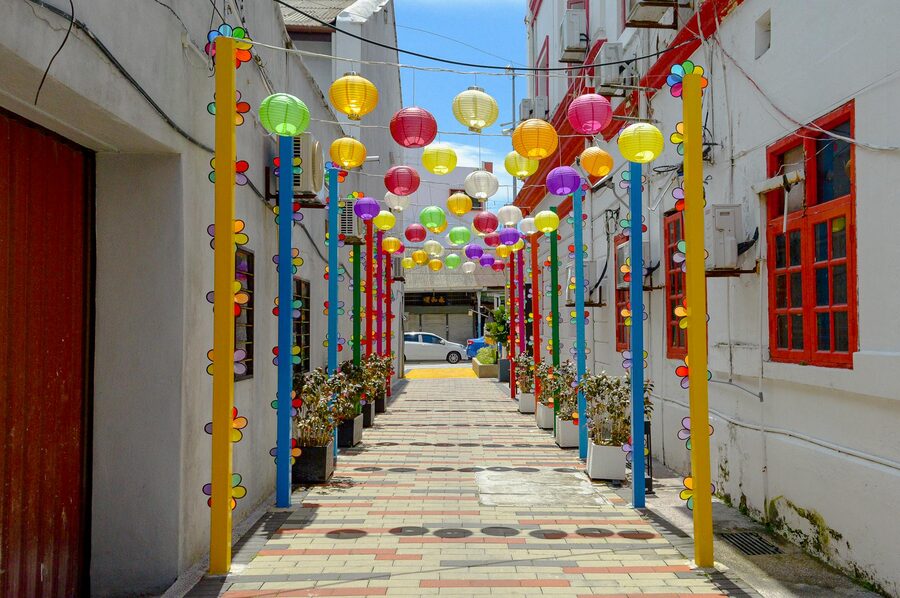 Red and gold lanterns hang in a decorated alley in Penang, Malaysia