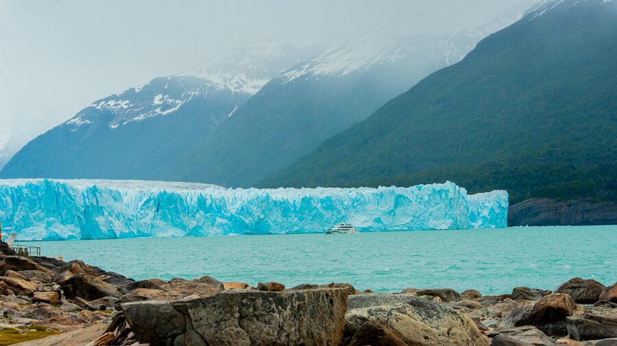 The Perito Moreno Glacier in Argentina with a backdrop of mountains and icy waters