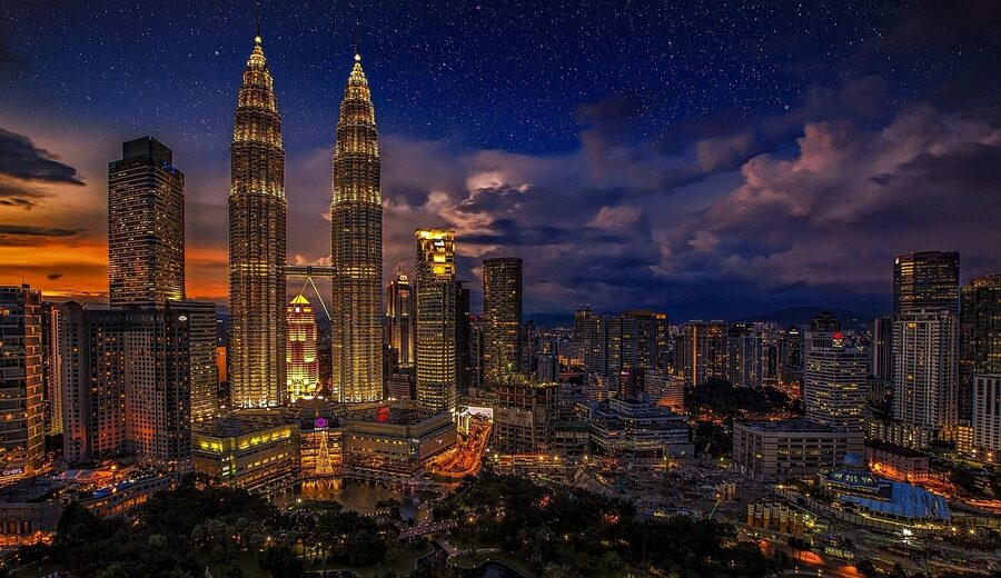 The Petronas Twin Towers illuminated at night in Kuala Lumpur