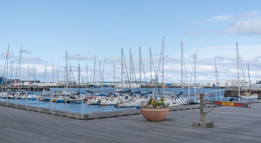 Boats moored in the Reykjavik harbour with the bay behind