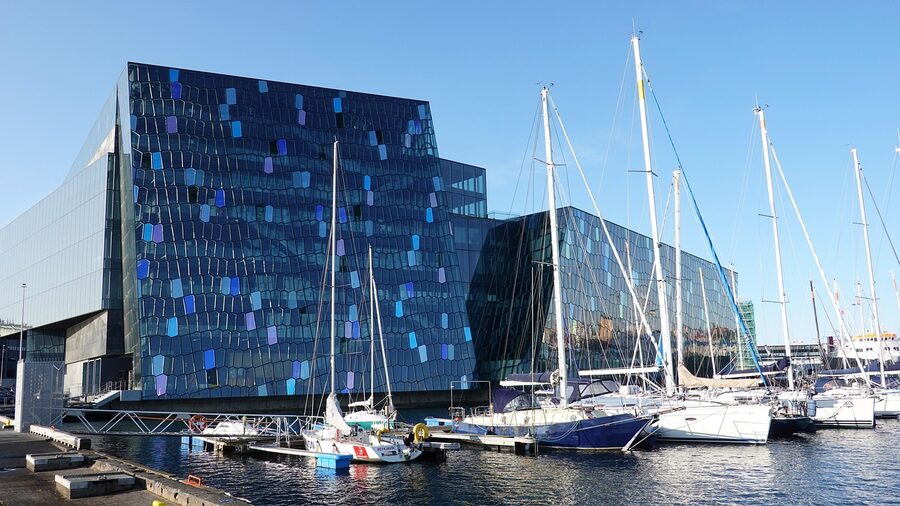 Harpa Concert Hall glass facade illuminated at night, Reykjavik