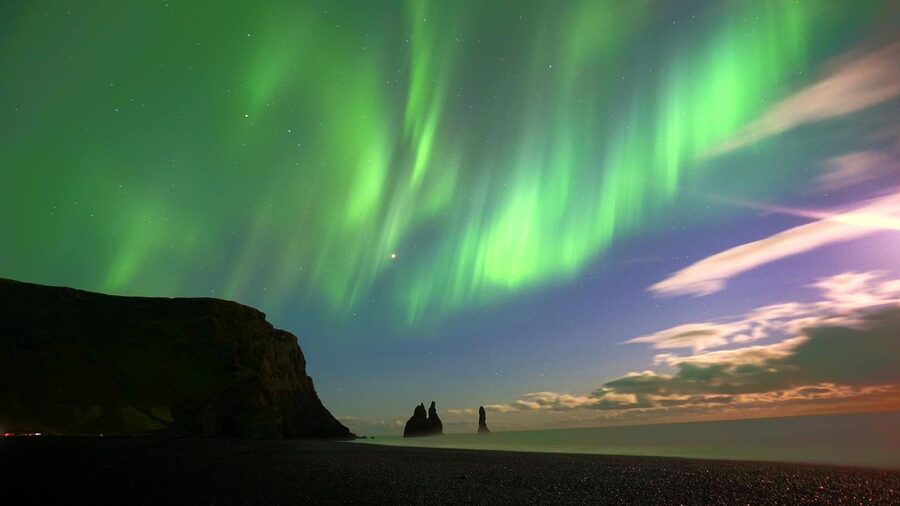 Aurora borealis over Reynisdrangar sea stacks at Vik, Iceland