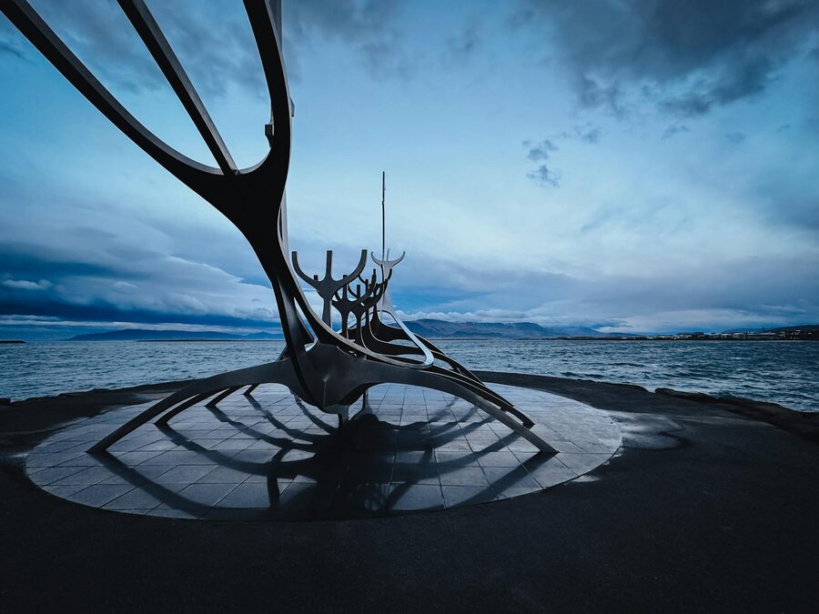 The Sun Voyager sculpture on the Reykjavik waterfront under a moody dusk sky