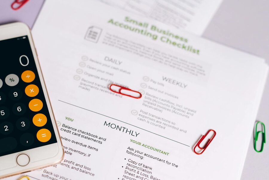 A travel checklist with documents on a desk