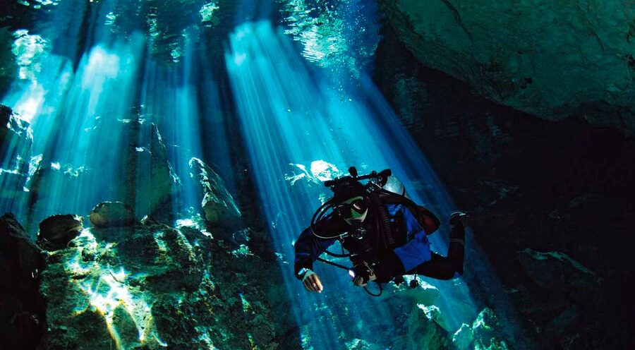 A diver descending into a cenote in the Yucatan, Mexico